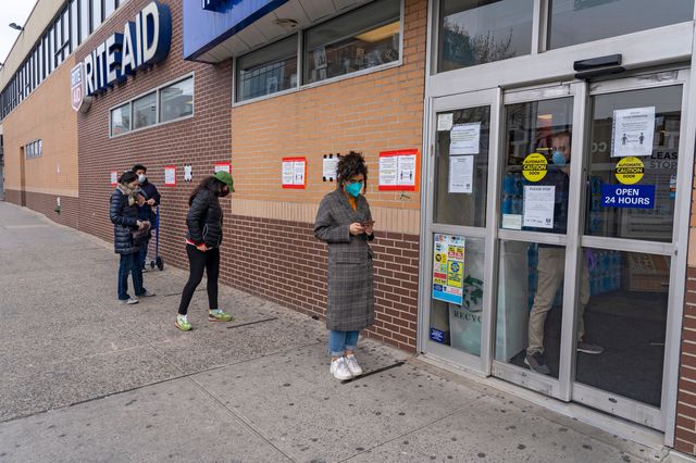 New Yorkers line up outside a Rite Aid in April.